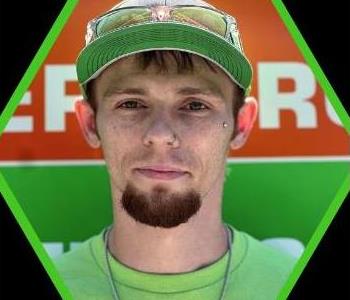 Male SERVPRO employee with a green shirt.